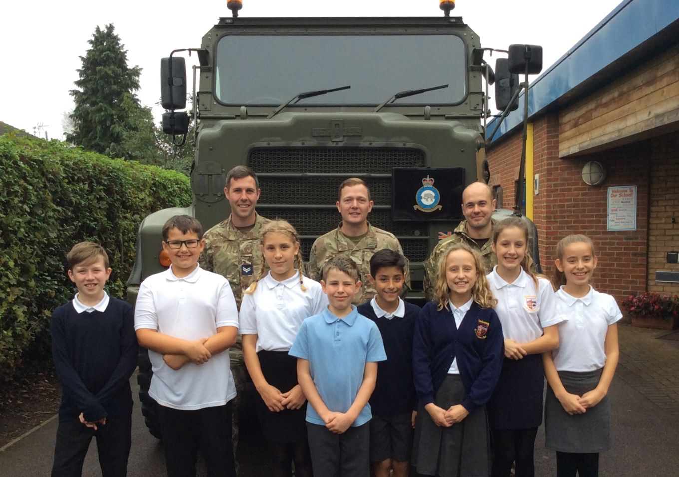 From left to right: Cpl Phillip Kapler, Sgt Terry Littler, SAC Luke Palmer with pupils from Newborough CE Primary School.