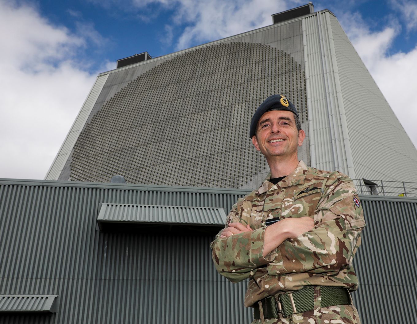 Air Vice-Marshal Godfrey smiling with arms folded outside RAF Fylingdales.