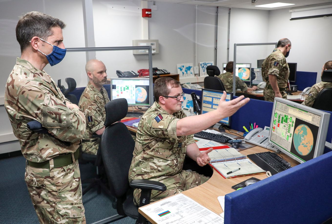 Air Vice-Marshal Godfrey and personnel in the office, with computer screens in the Space Operations Room.