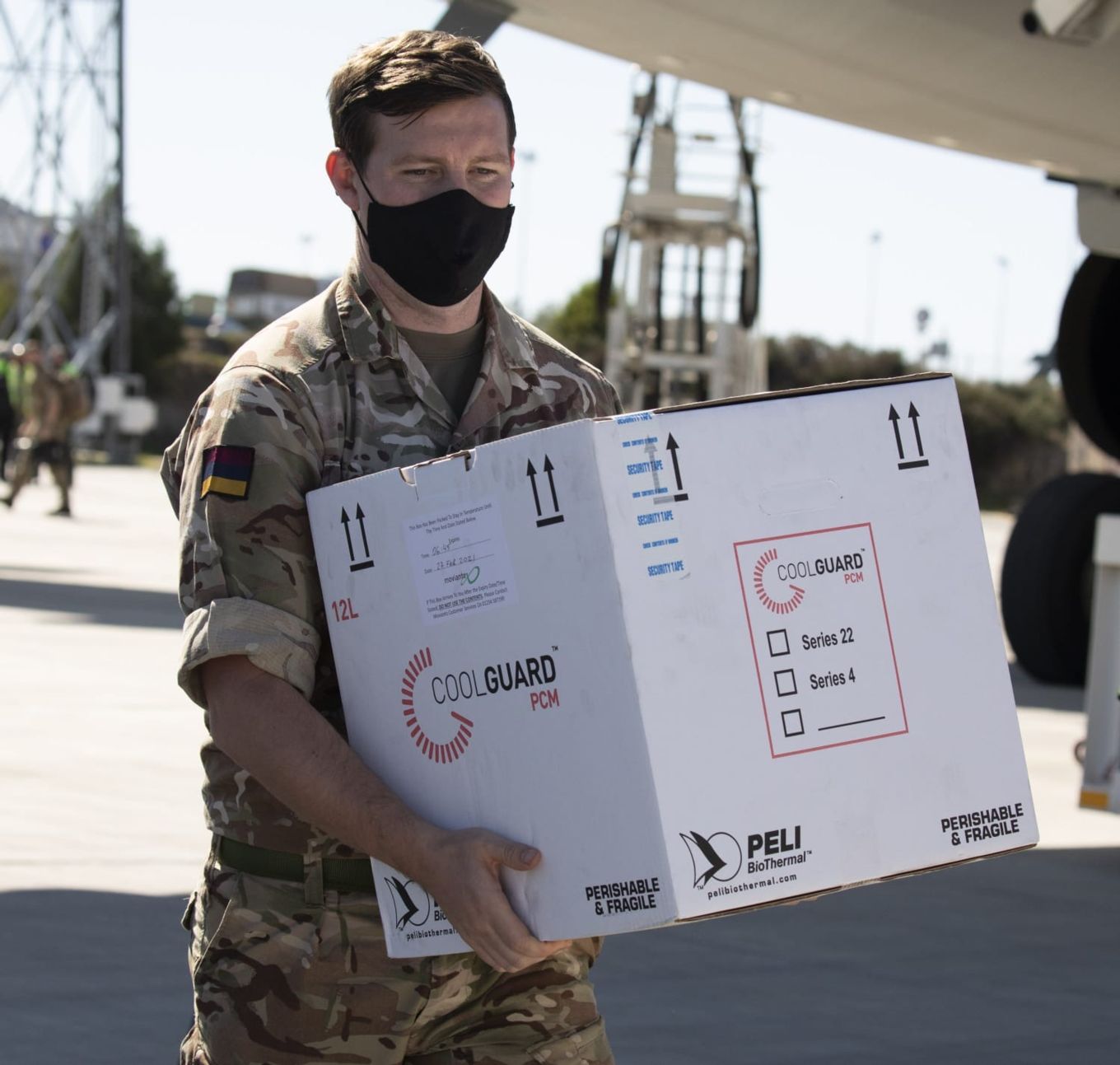Image shows a member of the British Army carrying a box.