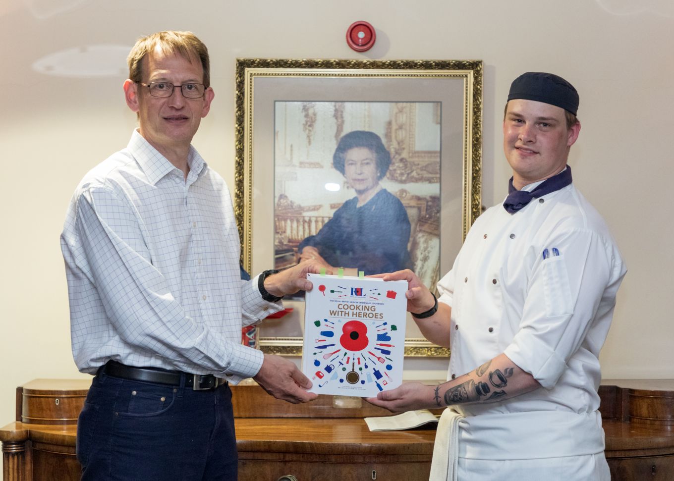AVM Gillespie congratulates SAC James Kerr on his recipe making it into the RBL Centenary Cookbook