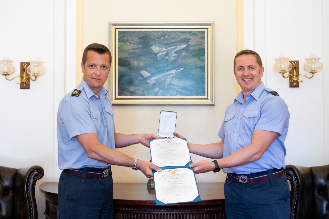 Wing Commander Clark being presented his award from RAF Marham Station Commander, Group Captain Beck