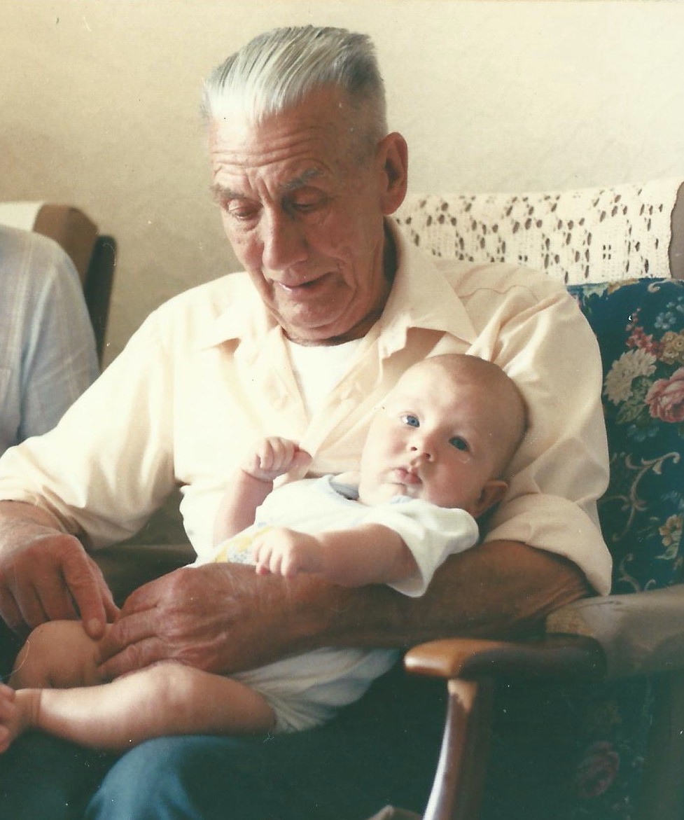 A great grandfather cradles his great grandson