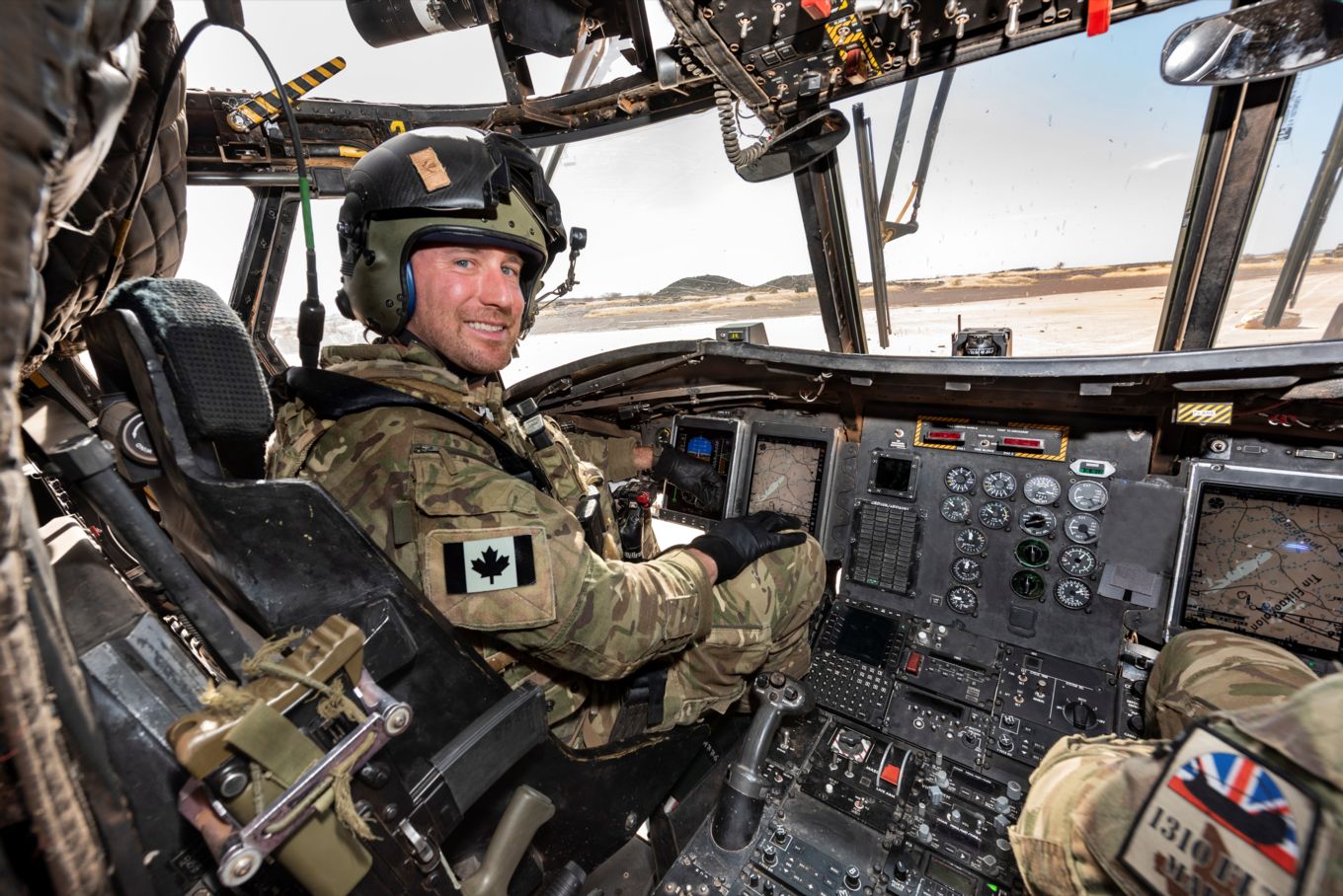 Image shows a Chinook helicopter pilot sat in the cockpit.