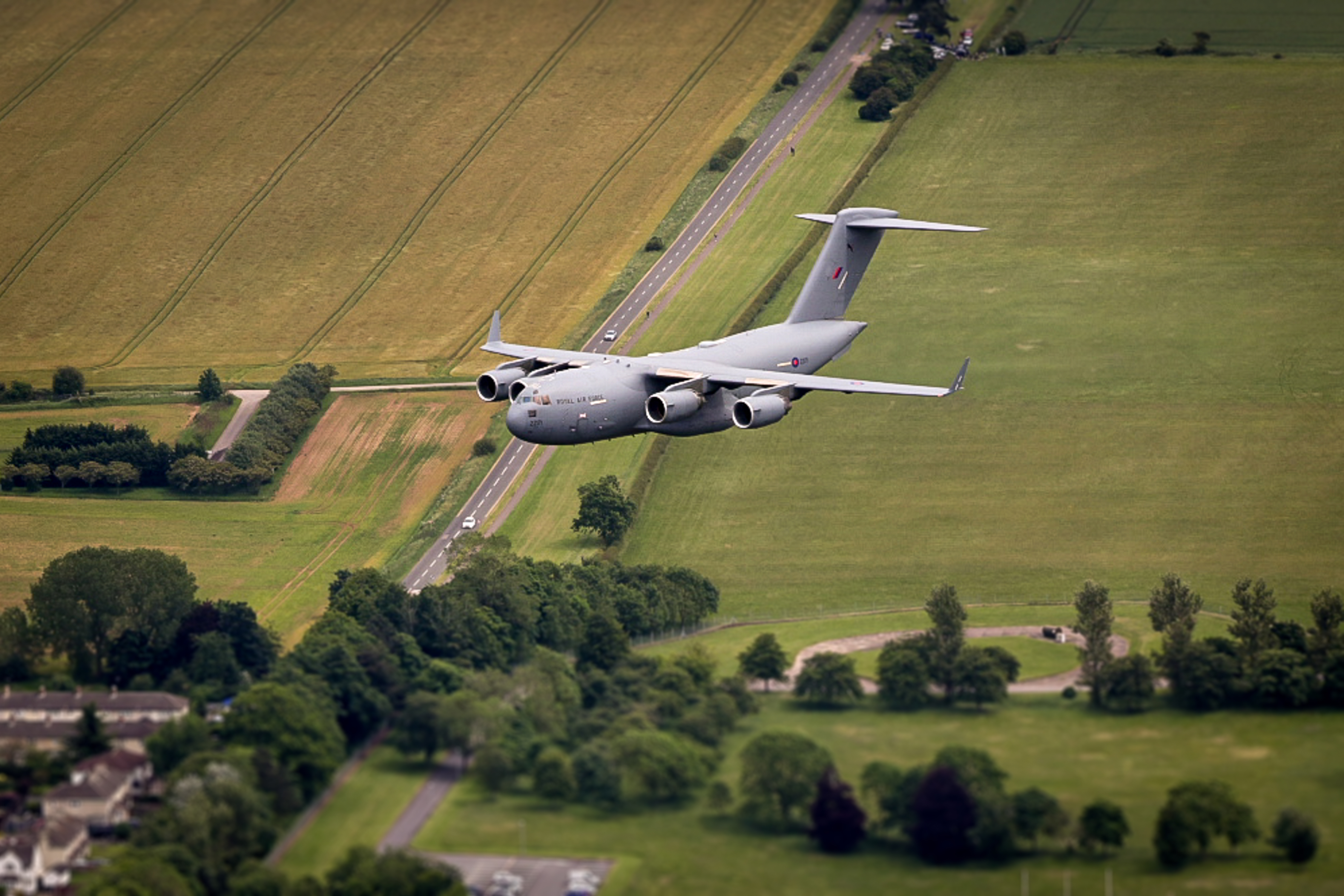 Image shows an RAF C-17 aircraft flying.