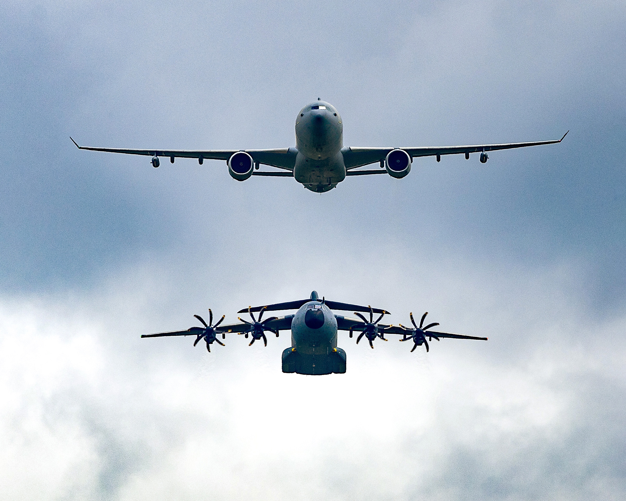 Image shows an RAF Voyager and A400M Atlas flying in formation.