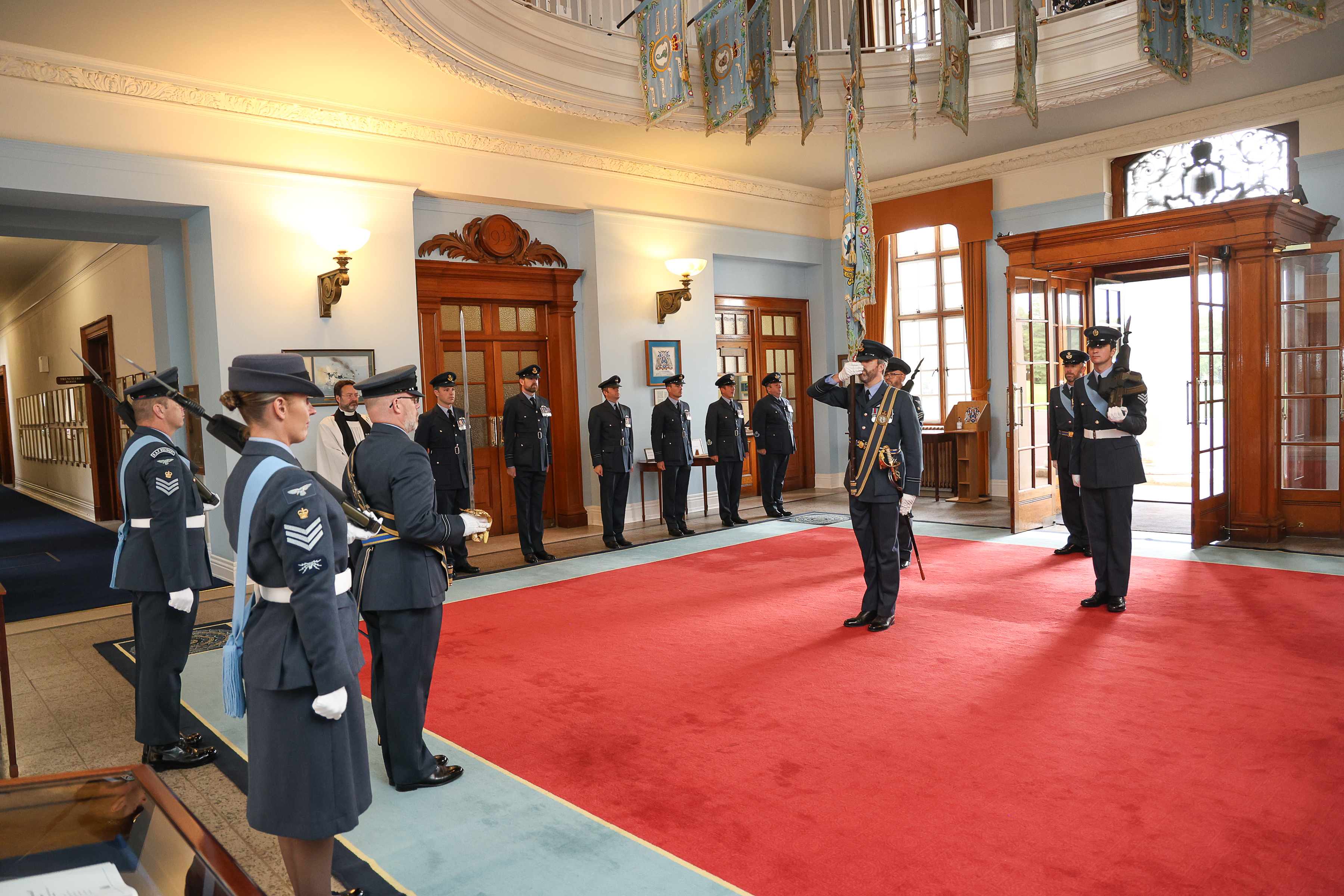 No.47 Squadron standard is marched into College Hall 