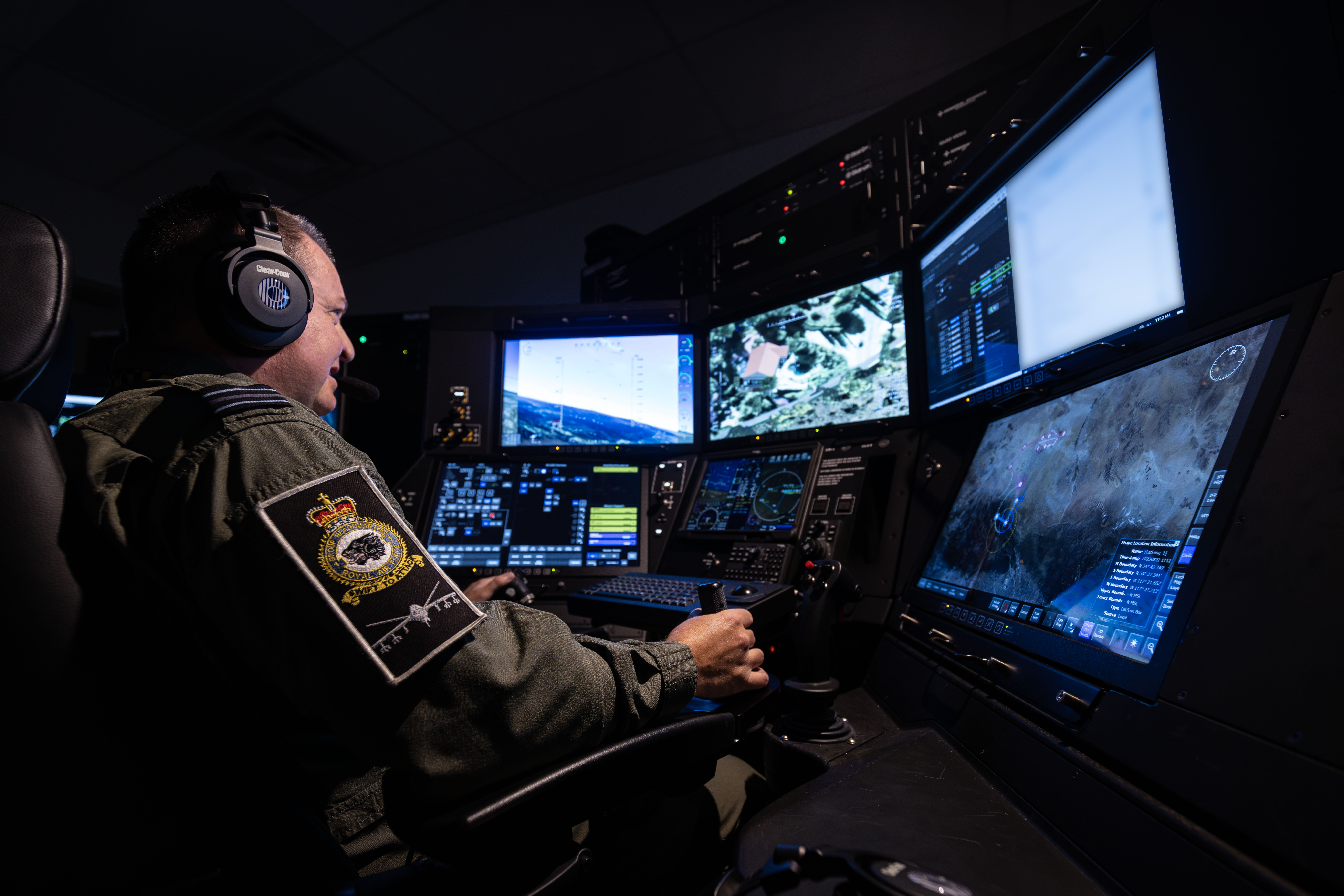 RAF pilot sat at high tech simulator training suite