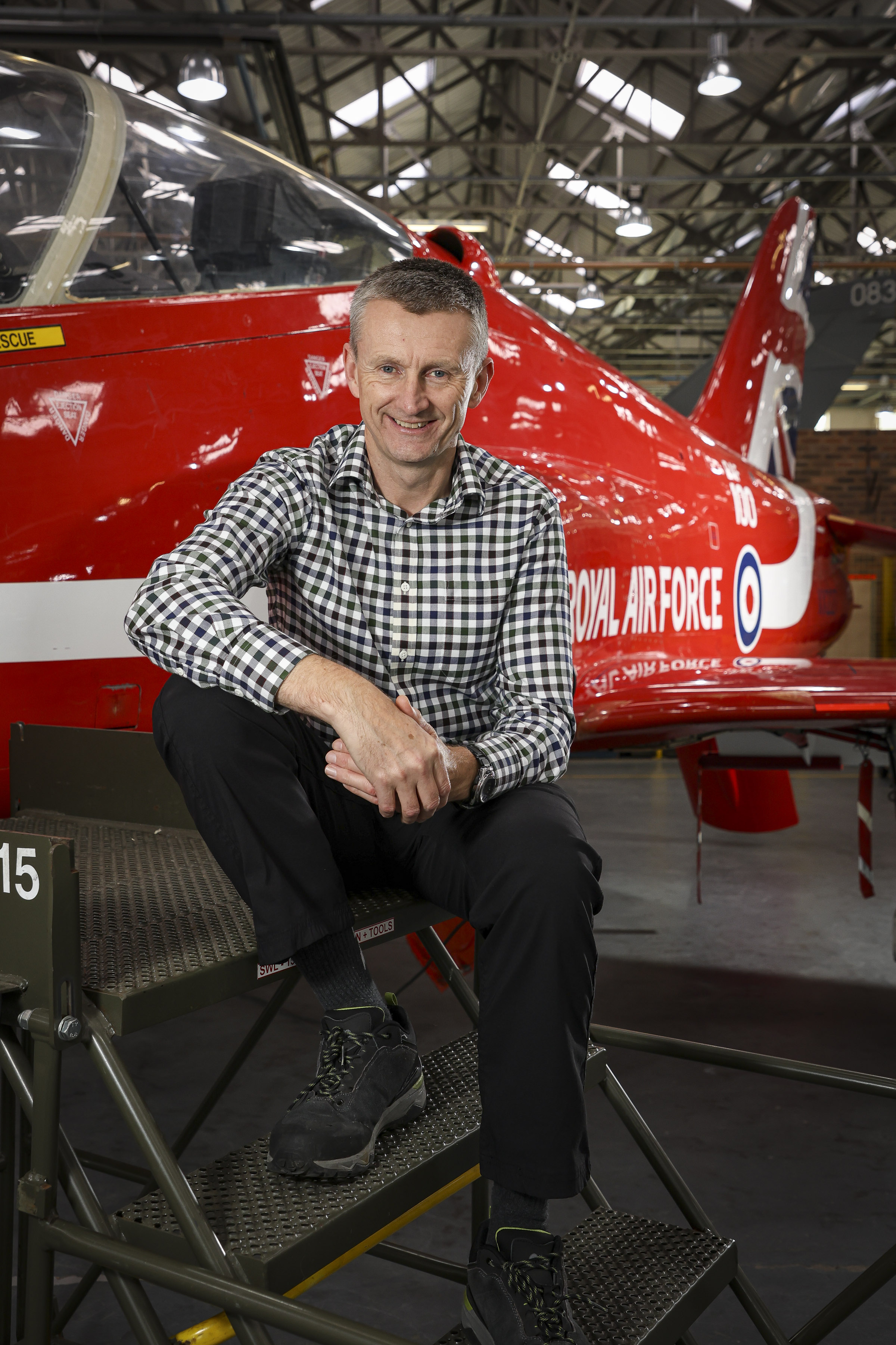 John Pickard in front of a Red Arrows Hawk within Number 1 School of Technical Training. 