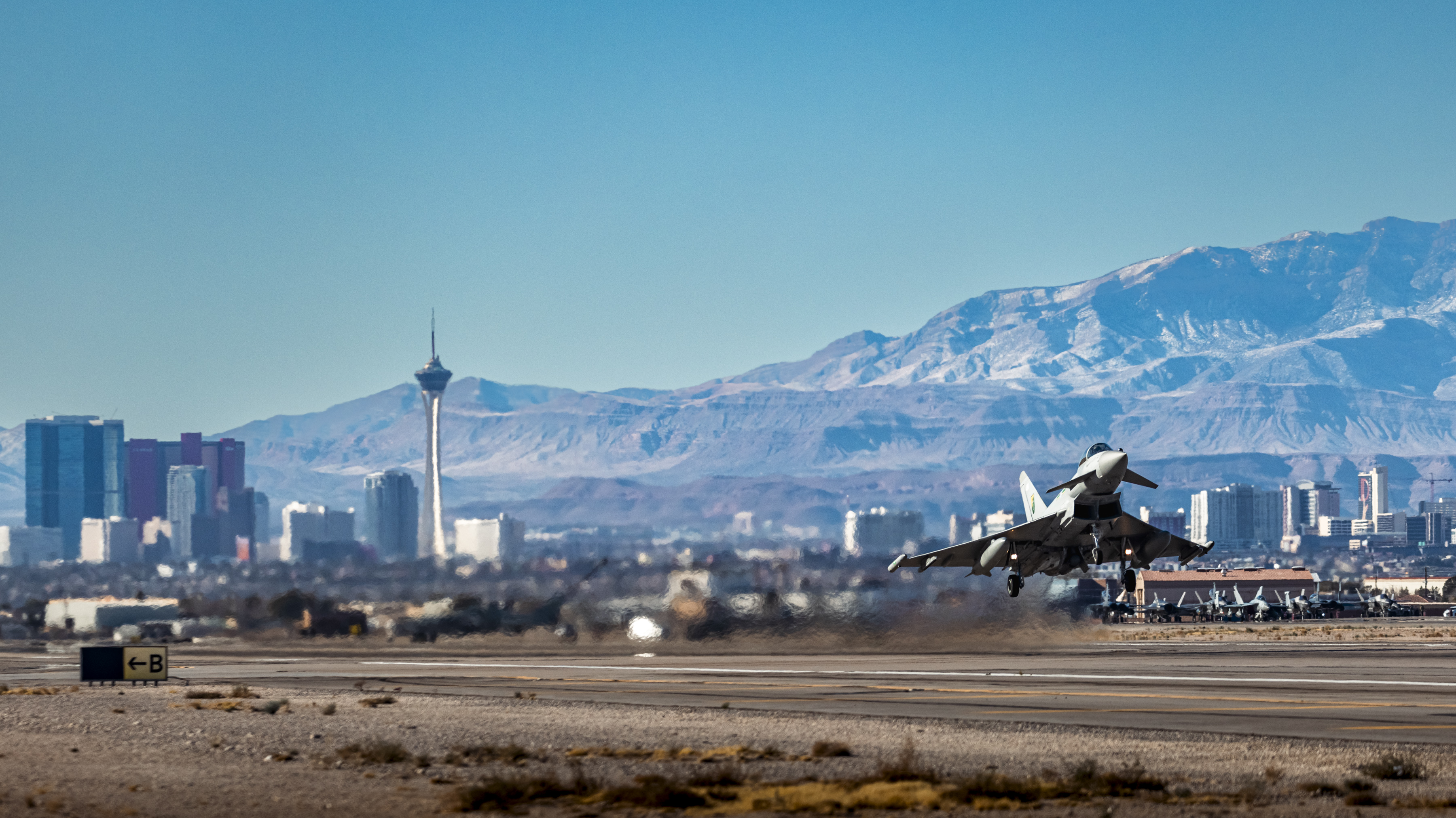 Typhoon taking off with mountains in the background