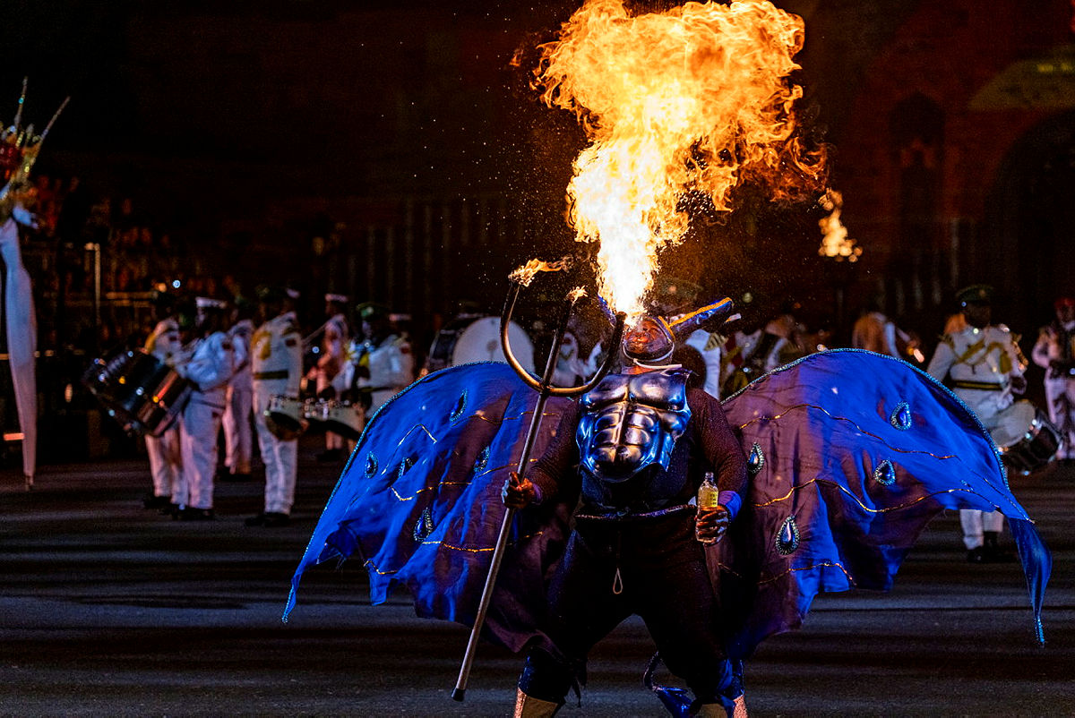 Fire breathing performer during dress rehearsal at night