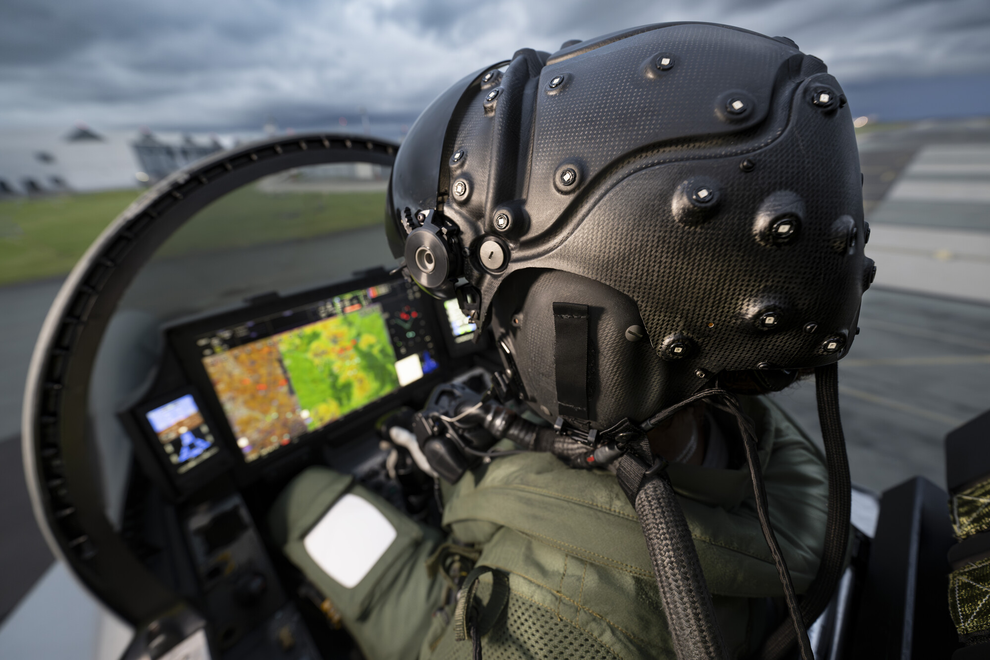 Image shows pilot from the back wearing helmet