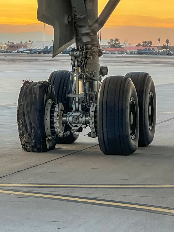 The four tyres pictured on the aircraft, with blown out tyre visible